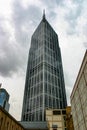 A striking glass and steel skyscraper reaches to the moody sky in Melbourne City Royalty Free Stock Photo