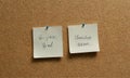 two sticky notes on cork board