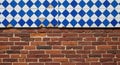Diamond patterned tiles above weathered red brick wall texture background Royalty Free Stock Photo