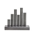 Unique Metallic Sculpture Featuring Five Cylindrical Columns of Varying Heights and Textures Arranged on a Rectangular Base Royalty Free Stock Photo