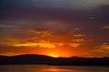 Striking orange and purple sunset over bay of water Royalty Free Stock Photo