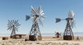 Desert wind pumps stand tall under a blue sky Royalty Free Stock Photo