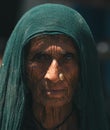 Striking portrait of an elderly Indian woman gazing at the camera with a wise look