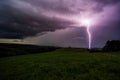 a purple lightning bolt in the night sky on a cloudy day Royalty Free Stock Photo