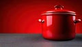 Bright red cooking pot against a vivid red background in a modern kitchen setting Royalty Free Stock Photo