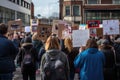 Striking school aged children in central London over climate change holding placards, Rear view of people with placards and