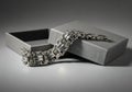 Silver Woven Bracelet Resting on a Gray Gift Box Royalty Free Stock Photo