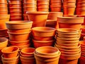 A Striking Stack of Orange Plastic Flower Pots Architectural Photography with Warm Tones and Geometric Composition Royalty Free Stock Photo