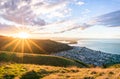 A striking sunset of a beautiful hilly seaside town