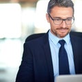 Striking up an online business deal. a businessman using a laptop in the office. Royalty Free Stock Photo