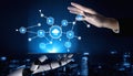 Futuristic Collaboration Between Robot Hand and Human Hand with Technology Icons and Cloud Data in Dark Urban Royalty Free Stock Photo