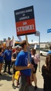 Striking Writers Guild of America member holding sign on picket line