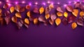 A string of autumn leaves and light bulbs on a dark purple background.