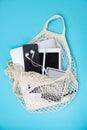 The string bag contains gadgets: an e-book, a phone, headphones, a tablet. Shop poster. Royalty Free Stock Photo