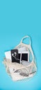 The string bag contains gadgets: an e-book, a phone, headphones, a tablet. Shop poster. Royalty Free Stock Photo