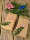 String and brown paper parcels with conifer decoration, check ri Royalty Free Stock Photo