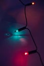 String of Christmas lights glowing at night. Christmas lights close up. Royalty Free Stock Photo