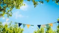 string of colorful pennant against blue sky in the garden Royalty Free Stock Photo