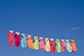 String of colorful socks against blue sky
