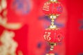 A string of lantern ornaments hung before the red spring couplets.The Chinese character on the lantern means `good luck` Royalty Free Stock Photo