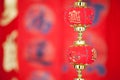 A string of lantern ornaments hung before the red spring couplets.The Chinese character on the lantern means `good luck` Royalty Free Stock Photo