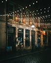 String lights on a rainy night on Stone Street, Manhattan, New York