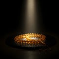 Under an ethereal spotlight, luminous amber prayer beads symbolize deep spiritual contemplation and inner peace Royalty Free Stock Photo