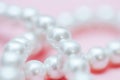 String of pearls delicate pink color, in soft focus, with highlights Royalty Free Stock Photo