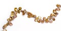 A string of shiny pearls lays elegantly on a pure white background, displaying simplicity and classic beauty