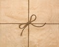 String tied in a bow on a brown recycled paper Royalty Free Stock Photo