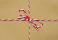 String tied in a bow, over brown paper Royalty Free Stock Photo