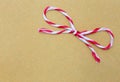 String tied in a bow, over brown paper Royalty Free Stock Photo