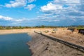 A string of transport belting in a gravel pit for transporting gravel and sand over long distances, belts go along the lake.