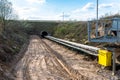 A string of transport belting in a gravel pit for transporting gravel and sand over long distances, the belts go under of the roa