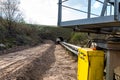 A string of transport belting in a gravel pit for transporting gravel and sand over long distances, the belts go under of the roa