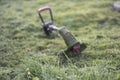 String trimmer lies on mown lawn middle of the yard Royalty Free Stock Photo