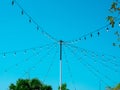 String wired bulbs from the pole in outdoor garden Royalty Free Stock Photo