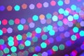 Strings of blurred multicolored holiday lights as a defocused background