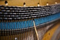 Strings, pegs and damper inside the old piano. The mechanism of musical instruments. Shallow depth of field Royalty Free Stock Photo