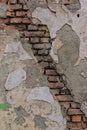 A strip of bricks in an old wall with destroyed plaster Royalty Free Stock Photo
