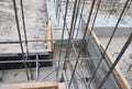 A strip foundation construction. A close-up of a concrete foundation with reinforced footing trenches, wood frames, rebars Royalty Free Stock Photo