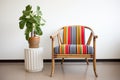 striped accent chair beside a bamboo plant