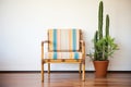 striped accent chair beside a bamboo plant Royalty Free Stock Photo