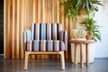 striped accent chair beside a bamboo plant Royalty Free Stock Photo