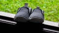 Striped baby boy shoe with blue and white on window sill