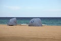 Striped beach shelters on Dania Beach