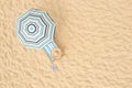 Striped beach umbrella near sunbed with vacationist`s stuff on sandy coast, aerial view. Space for text Royalty Free Stock Photo