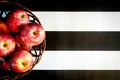 Striped black and white background. Red apples on striped black and white background. Flat lay, top view, space for text