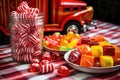 striped candies grouped near a bright red toy fire truck Royalty Free Stock Photo