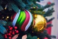 Striped Christmas ball and red mistletoe berry, close-up Royalty Free Stock Photo